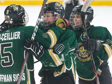 Gael Bah-Ceiller, (from left), Lukas Murphy, and Daniel McDowell of the Gloucester Rangers in the Minor Peewee AA division celebrate their win over the Clifton Park Dynamo team at the end of their game as the annual Bell Capital Cup hockey tournament for Peewee and Atom level players gets underway at the Bell Sensplex and various arenas across the city.