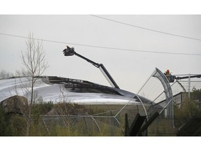 Firefighters at Chester Zoo after a fire broke out in the Monsoon Forest habitat enclosure of the zoo, in Chester, England, Saturday Dec. 15, 2018. The fire forced keepers to evacuate visitors and move animals away from the fire, with winds fanning flames in the inflatable roof of the building.(Peter Byrne/PA via AP) ORG XMIT: LON837