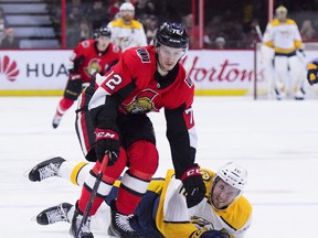 Nashville Predators centre Colton Sissons (10) hits the ice as Senators defenceman Thomas Chabot knocks him off the puck during first-period action in Ottawa on Monday, Dec. 17, 2018. (THE CANADIAN PRESS)