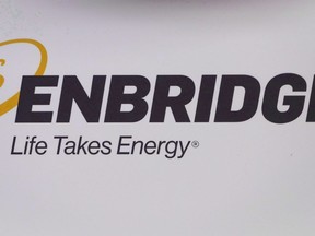 The Enbridge logo is shown at the company's annual meeting in Calgary on May 9, 2018. Enbridge is getting a $14.7-million refund on fees it paid Canada's federal energy regulator for a pipeline it won't get to build.