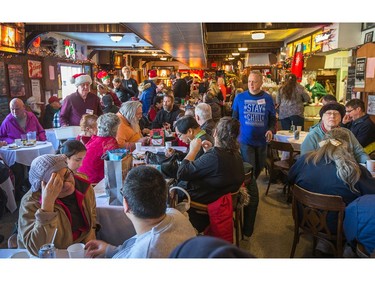 A full house as the annual Carleton Tavern Christmas Dinner was held from 11am to 3pm with about 120 volunteers taking turns serving meals to anyone who wanted to come in and enjoy some company, live music and roast turkey with all the trimmings including dessert.  Photo by Wayne Cuddington/ Postmedia