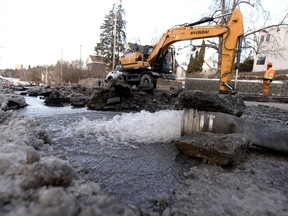 Water flows out of a pump hose after a water main burst on Boulevard Alexandre-Taché near the Université du Québec en Outaouais in Gatineau on Tuesday, December 18, 2018.