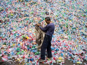 A Chinese worker sorts plastic bottles.