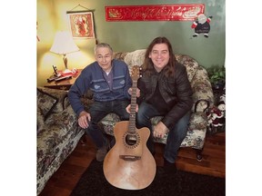 Edward Sheppard and Alan Doyle of the band Great Big Sea pose with Sheppard's new guitar, which Doyle replaced after Sheppard's guitar went missing, in a handout photo. Two famous Newfoundlanders stepped in to help an elderly veteran whose guitar went missing earlier this month. THE CANADIAN PRESS/HO-Aaron Small MANDATORY CREDIT