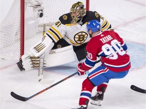 Boston Bruins goaltender Jaroslav Halak (41) stops Montreal Canadiens left wing Tomas Tatar (90) during first period NHL hockey action in Montreal, Monday, Dec. 17, 2018.