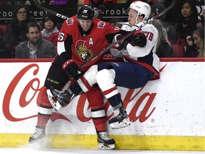 Senators forward Zack Smith collides with Capitals defenceman Tyler Lewington during the second period of Saturday's game in Ottawa. The Capitals won 3-2.