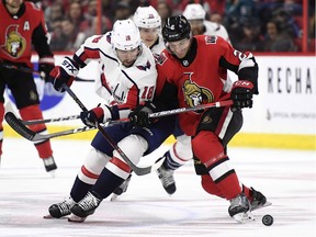 Ottawa Senators defenceman Dylan DeMelo (2) keeps Washington Capitals centre Chandler Stephenson (18) away from the puck during first period NHL hockey action in Ottawa, Saturday December 29, 2018.