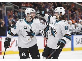 San Jose Sharks' Melker Karlsson (68) and Erik Karlsson (65), celebrate a goal against the Edmonton Oilers during third period NHL action in Edmonton on Saturday, December 29, 2018.
