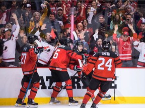 Canada's Barrett Hayton, from left to right, Noah Dobson, Morgan Frost and Ty Smith celebrate Frost's goal against Denmark during first period IIHF world junior hockey championship action in Vancouver, on Wednesday December 26, 2018.
