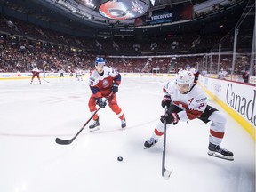 Switzerland's Philipp Kurashev, right, is watched by Czech Republic's Martin Necas as he reaches for the puck during third period IIHF world junior hockey action in Vancouver, on Wednesday December 26, 2018.