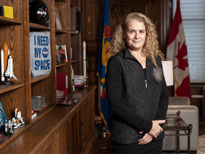 Governor General Julie Payette stands next to a shelf featuring memorabilia from her career as an astronaut, in her office at Rideau Hall in Ottawa on Dec. 11, 2018.