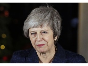 Britain's Prime Minister Theresa May delivers a speech outside 10 Downing Street in London, Wednesday, Dec. 12, 2018.