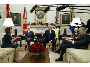 FILE - In this Tuesday, Dec. 11, 2018 file photo, House Minority Leader Rep. Nancy Pelosi, D-Calif., Vice President Mike Pence, President Donald Trump, and Senate Minority Leader Chuck Schumer, D-N.Y., argue during a meeting in the Oval Office of the White House in Washington. On Friday, Dec. 14, 2018, The Associated Press has found that stories circulating on the internet that Democrats gave a $150 billion payout from the U.S. treasury to Iran, are untrue.