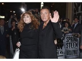 FILE - In this Oct. 12, 2017 file photo, musician Bruce Springsteen and his wife Patti Scialfa exit the stage door after the "Springsteen On Broadway" opening night performance at the Walter Kerr Theatre in New York. Director Thom Zimny's "Springsteen on Broadway" film will appear on Netflix early in the morning of Dec. 16, hours after the singer's 236th and last performance.