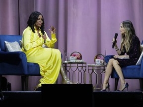 Former first lady Michelle Obama, left, is interviewed by Sarah Jessica Parker during an appearance for her book, "Becoming: An Intimate Conversation with Michelle Obama" at Barclays Center Wednesday, Dec. 19, 2018, in New York.