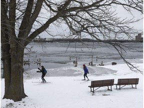 Two cross country skiers enjoy the cold winter weather along the Ottawa River in Ottawa.
