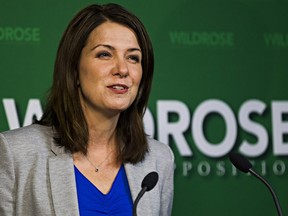 Danielle Smith gives a statement regarding two Wildrose MLAs who crossed the floor to the Progressive Conservative Party at the Legislature Annex in Edmonton, Alta., on Monday, Nov. 24, 2014.
