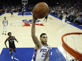 The Philadelphia 76ers' Ben Simmons goes up for a dunk during the first half of an NBA basketball game against the Toronto Raptors on Saturday, Dec. 22, 2018, in Philadelphia.