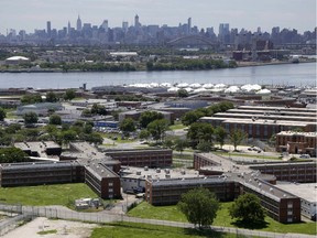 FILE - In a June 20, 2014, file photo, the Rikers Island jail complex stands in New York with the Manhattan skyline in the background.