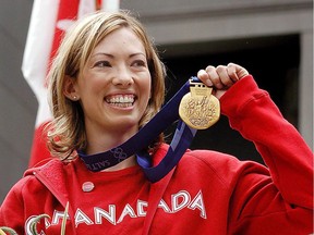 FILE--Canadian cross-country skier Beckie Scott displays her gold medal she was awarded at a ceremony in Vancouver, Friday, June 25, 2004.