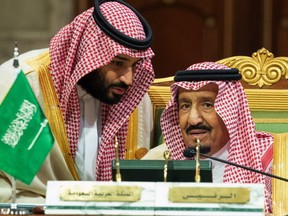 In this Dec. 9, 2018 file photo, released by the state-run Saudi Press Agency, Saudi Crown Prince Mohammed bin Salman, left, speaks to his father, King Salman, at a meeting of the Gulf Cooperation Council in Riyadh, Saudi Arabia.