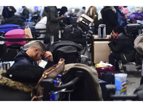 Passengers stranded at Gatwick airport, as the airport remains closed after drones were spotted over the airfield last night and this morning, in Gatwick, England, Thursday, Dec. 20, 2018. Drones spotted over the runway forced the shutdown of London's Gatwick Airport on Thursday during one of the busiest times of the year, stranding or delaying tens of thousands of Christmas-season travelers and setting off a hunt for the operator of the intruding aircraft.