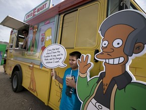 FILE - In this March 15, 2015, file photo, an Apu cutout is displayed at a Simpsons Kwik-E-Mart Truck in Austin, Texas. Comedian Hari Kondabolu released a film, "The Problem With Apu," documenting stereotypes he saw with the character and its effect on South Asian entertainers.