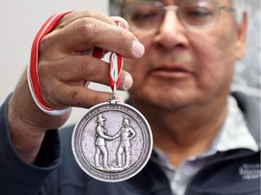 Chief Clifford Bull of the Lac Seul First Nation shows the 1873 treaty medal handed down for decades from chief to chief at the band office in Frenchman's Head, Ont., on Tuesday, April 24, 2018.