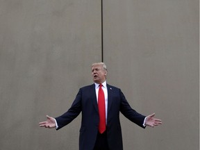 FILE - In this March 13, 2018, file photo, President Donald Trump speaks during a tour as he reviews border wall prototypes in San Diego. A relentless stream of U.S. policy shifts in 2018 has amounted to one of the boldest attacks on all types of immigration that the country has ever seen. Some see it as a tug-of-war between foundational national ideals and a fight for a new path forward led by Trump.