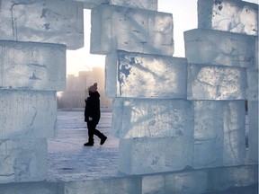 A woman walks behind an ice wall.