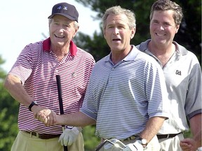In this file photo taken on July 06, 2001, then-U.S. president George W. Bush, former president George H.W. Bush and Jeb Bush are seen after finishing a round of golf at the Cape Arundel Golf Club in Kennebunkport, Maine.