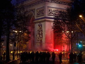 Demonstrators on the Champs Elysees in Paris face riot police during a protest against rising gas prices and living costs.