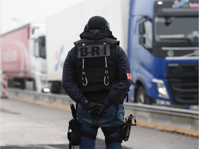 A member of the French police unit BRI (Research and Intervention Brigade - Brigades de recherche et d'intervention) stands guard at the border with Germany in Strasbourg, on December 12, 2018, as part of searches in order to find the gunman who opened fire near a Christmas market the night before, in Strasbourg, eastern France. - Hundreds of security forces were deployed in the hunt for a lone gunman who killed at least two people and wounded a dozen others at the famed Christmas market in Strasbourg, with the French government raising the security alert level and reinforcing border controls.