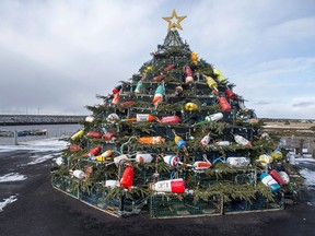 A Christmas tree made of lobster traps is seen on Cape Sable Island, on Nova Scotia's South Shore, on December 11, 2016. They first started appearing along Canada's east coast about 10 years ago: towering artificial Christmas trees made from carefully stacked lobster traps. Adorned with colourful buoys, twinkling lights and evergreen boughs, they are becoming regular fixtures in fishing communities across Atlantic Canada. "They are popping up everywhere," says Suzy Atwood, tourism development officer for Barrington, N.S., which assembled one of the region's first trap trees in 2009.