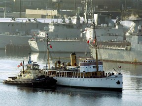 The tug Point Valiant guides the 90-year-old CSS Acadia along the waterfront in Halifax to a shipyard for conservation work on Monday, Nov. 17, 2003. The Nova Scotia government says it's making repairs to the only vessel to have survived the Halifax explosion.