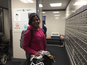 Samira Umba waits in the lobby to move her belongings back in her apartment at 251 Donald St. on Dec. 15, 2018. A fire forced the evacuation of about 220 residents on Dec. 12 and residents have been living in hotels and with residents.