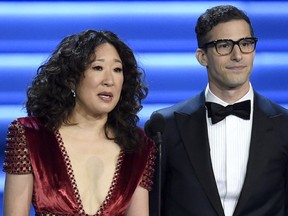 Sandra Oh and Andy Samberg present an award at the 70th Primetime Emmy Awards in Los Angeles. Oh and Samberg will share host duties at next month's Golden Globe ceremony.