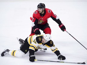 Senators defenceman Dylan DeMelo pushes Bruins centre Sean Kuraly to the ice during the first period of a game on Oct. 23, 2018.