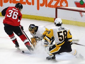 Ottawa Senators centre Colin White (36) shoots the puck on Pittsburgh Penguins goaltender Casey DeSmith (1) as Chris Letang (58) looks on during overtime in Ottawa on Saturday, Dec. 8, 2018.