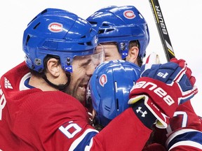 Canadiens' Shea Weber, left, celebrates with teammates Jonathan Drouin (92) and Brett Kulak after scoring against the New York Rangers in Montreal on Saturday, Dec. 1, 2018.