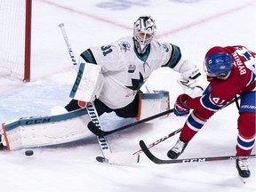 San Jose Sharks goaltender Martin Jones makes a kick save off Montreal Canadiens' Paul Byron during first period NHL hockey action in Montreal on Sunday, Dec. 2, 2018.