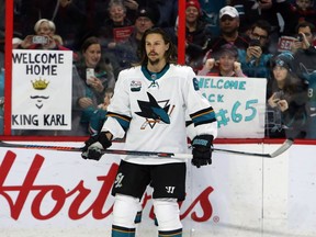 The San Jose Sharks' Erik Karlsson is welcome back to Ottawa by fans holding signs during warmup on Saturday, Dec. 1, 2018.