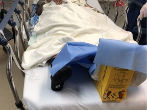 The left foot of Leila Giama is under protective wrapping as she lies in a room at the Civic campus of The Ottawa Hospital on Sunday. Giama, 26, was struck by an OC Transpo bus while crossing an intersection late Saturday.