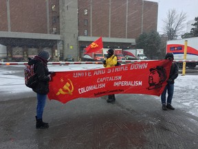 About a dozen people outside the Canada Post sorting facility in Ottawa, carrying the Revolutionary Communist Party banner try interfering with postal delivery . Errol McGihon
