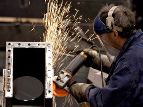 A worker grinds metal in a factory in Quebec City. Statistics Canada says the economy jobs in August. Employment increased by 94,100 in November, with broad-based gains across industries of mostly full-time jobs.