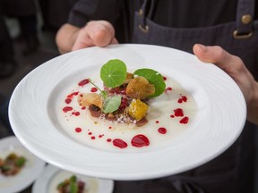 Chef Yannick LaSalle of Restaurant Les Fougères with a plate of duck magret, black garlic mustard, red currants and beets.
