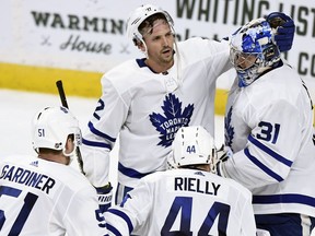 Toronto Maple Leafs defencemen Jake Gardiner (51), Ron Hainsey (2) and Morgan Rielly (44) congratulate goaltender Frederik Andersen (31) after the win over the Minnesota Wild on Saturday, Dec. 1, 2018.