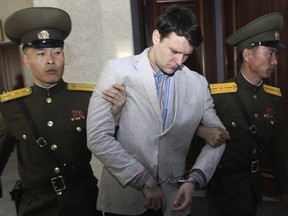 American student Otto Warmbier is escorted at the Supreme Court in Pyongyang, North Korea on March 16, 2016. A federal judge has ordered North Korea to pay more than $500 million in a wrongful death suit filed by the man's parents.