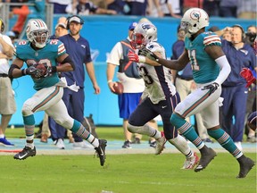Miami Dolphins wide receiver DeVante Parker pitches to Miami Dolphins running back Brandon Bolden before scoring as the Miami Dolphins defeat the New England Patriots in the final seconds at Hard Rock Stadium in Miami Gardens on Sunday.