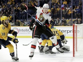 The Ottawa Senators' Brady Tkachuk tries to control a rebound in front of the Nashville Predators' Ryan Hartman in the first period of an NHL hockey game Tuesday, Dec. 11, 2018, in Nashville.